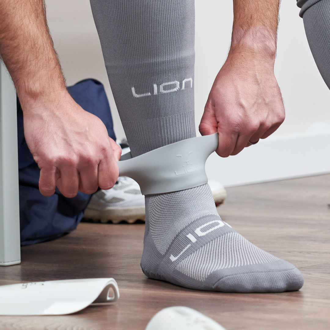 Grey silicone band holder for shin pad