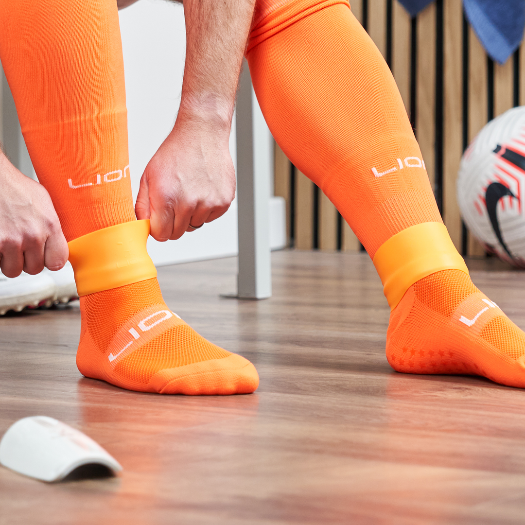 Orange silicone holder for shin pad